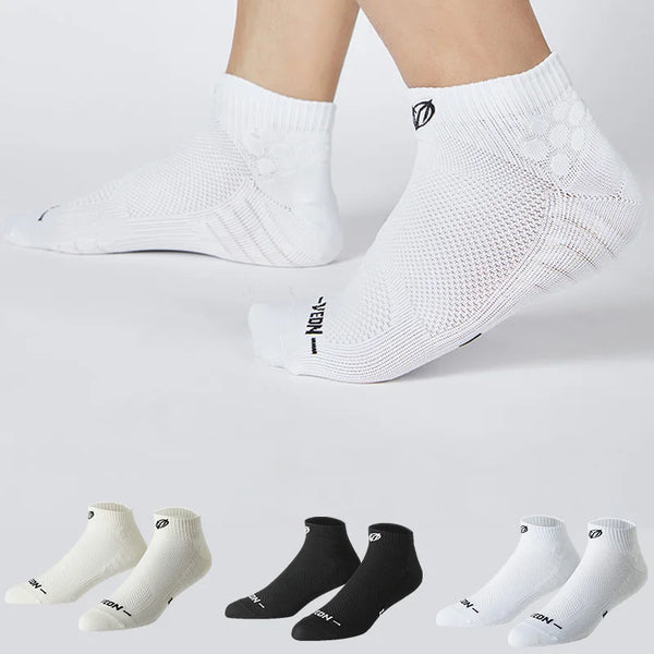 A collection of white and black performance ankle socks for running and athletic activities shown from various angles.