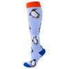 A pair of blue compression socks featuring a repeating pattern of black penguins on the foot and ankle.