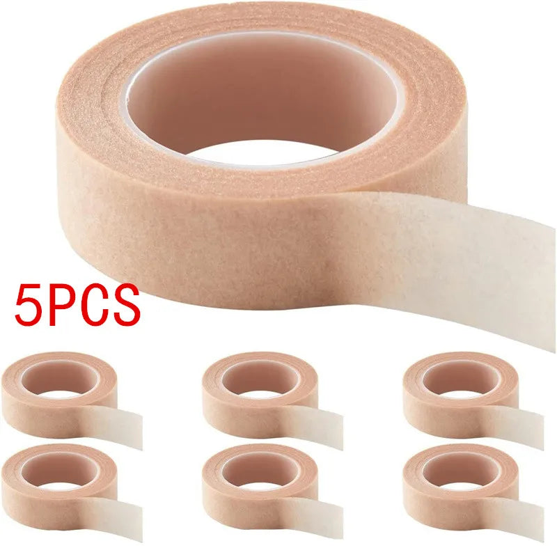 Five rolls of pink eyelash extension tape for precision application