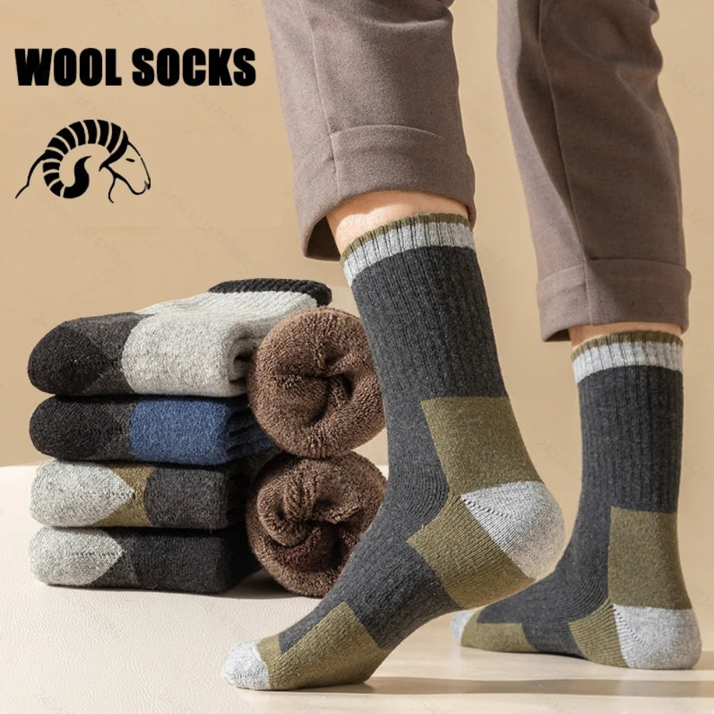 A person is wearing thick, patterned wool socks while standing, with a stack of similar socks nearby.