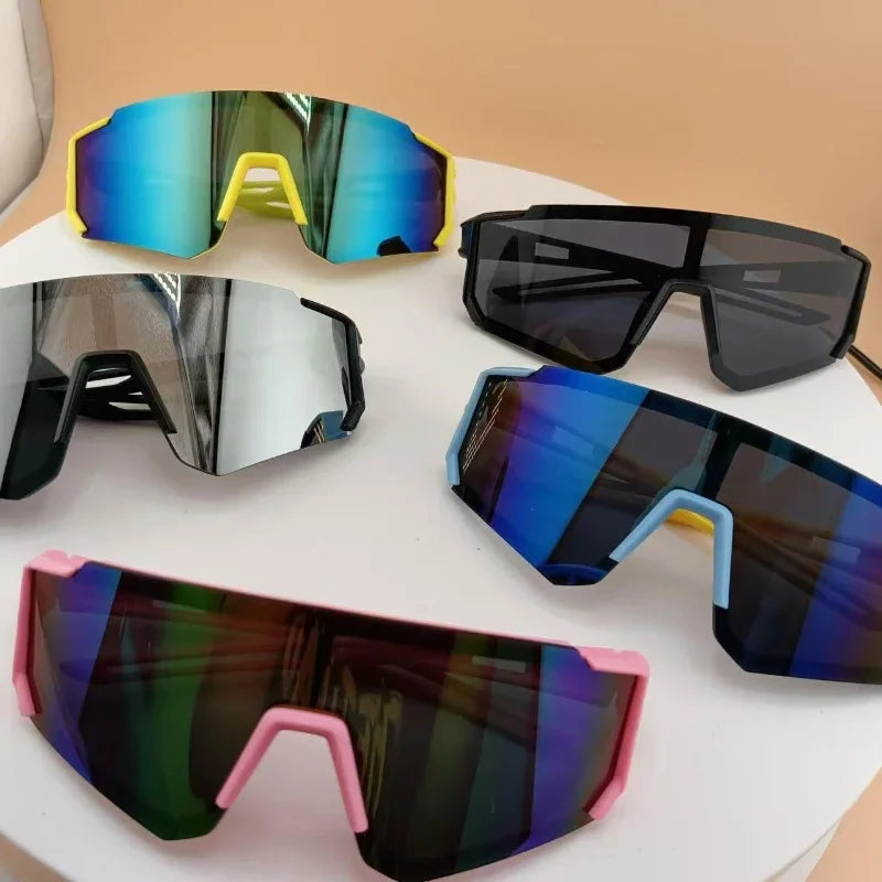 A collection of five pairs of kids UV protection sports sunglasses in various colors and styles.