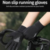 Black non-slip running gloves being worn on a bicycle handlebar.