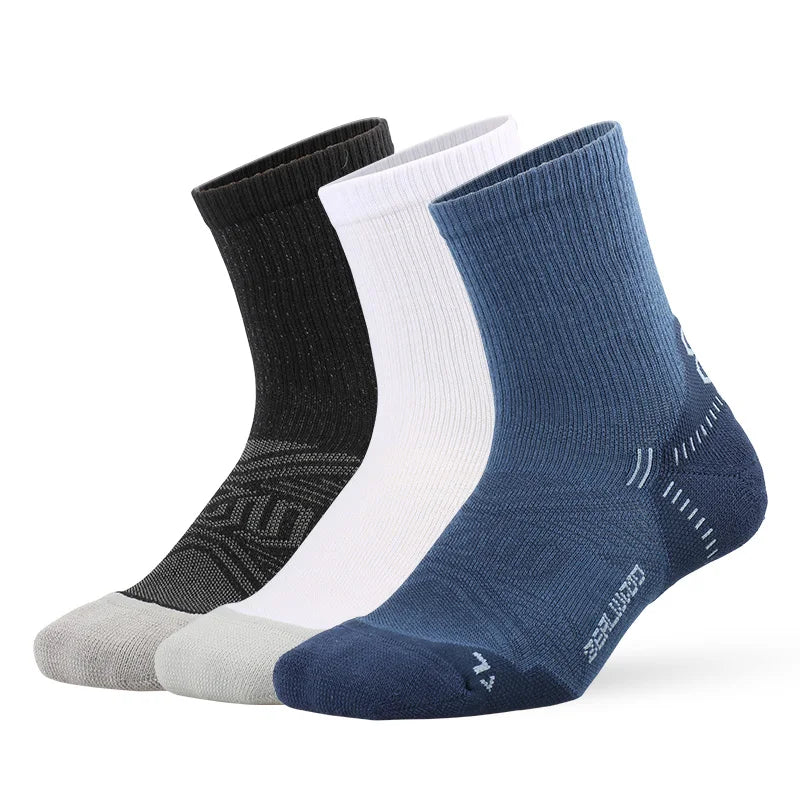 A stack of four breathable performance running socks in black, white, gray, and navy blue.