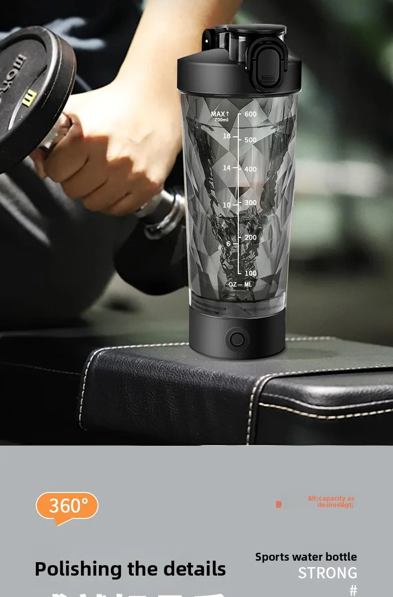 A clear, insulated sports water bottle with a black lid and measurement markings is shown next to a hand.