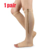 One pair of beige compression stockings with a zipper on the calf and ankle.