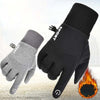 A pair of black and gray thermal fleece touchscreen gloves shown against a blurred background with a flame effect.