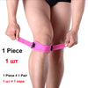 Pink adjustable patella tendon support brace worn on the knee of a person.