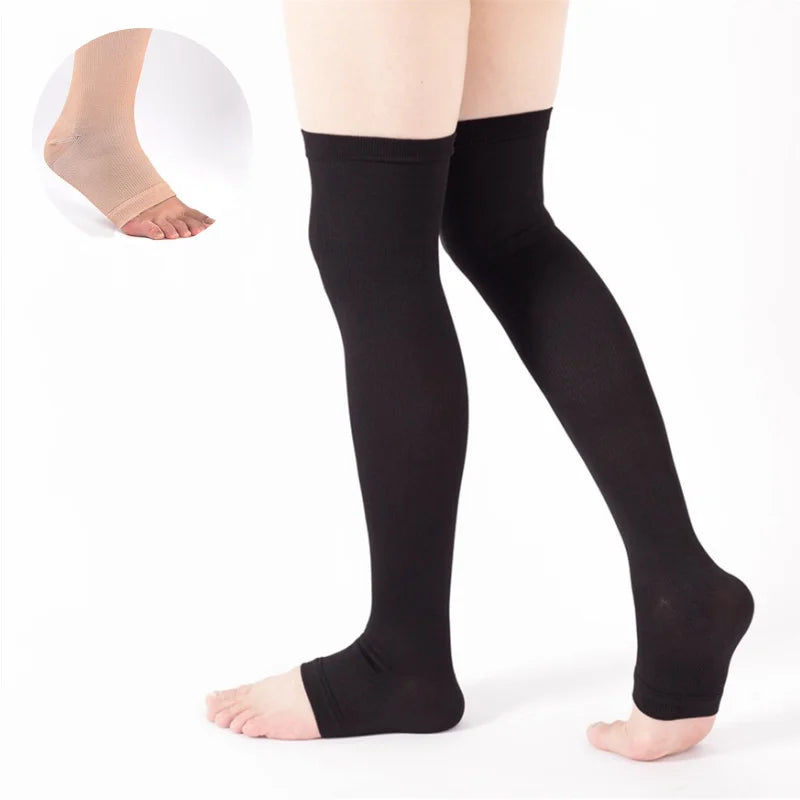 Black compression thigh high socks shown on a model's legs and a foot.