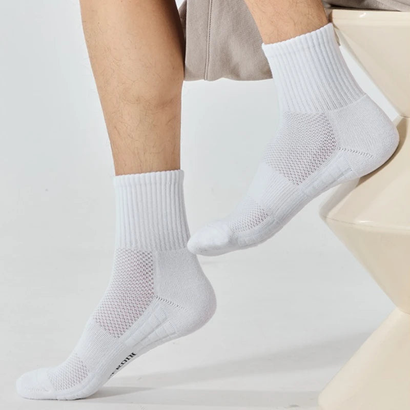 White breathable sports performance socks worn on a person's foot