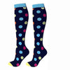 Pair of navy blue compression elastic socks with colorful polka dots and light blue cuffs