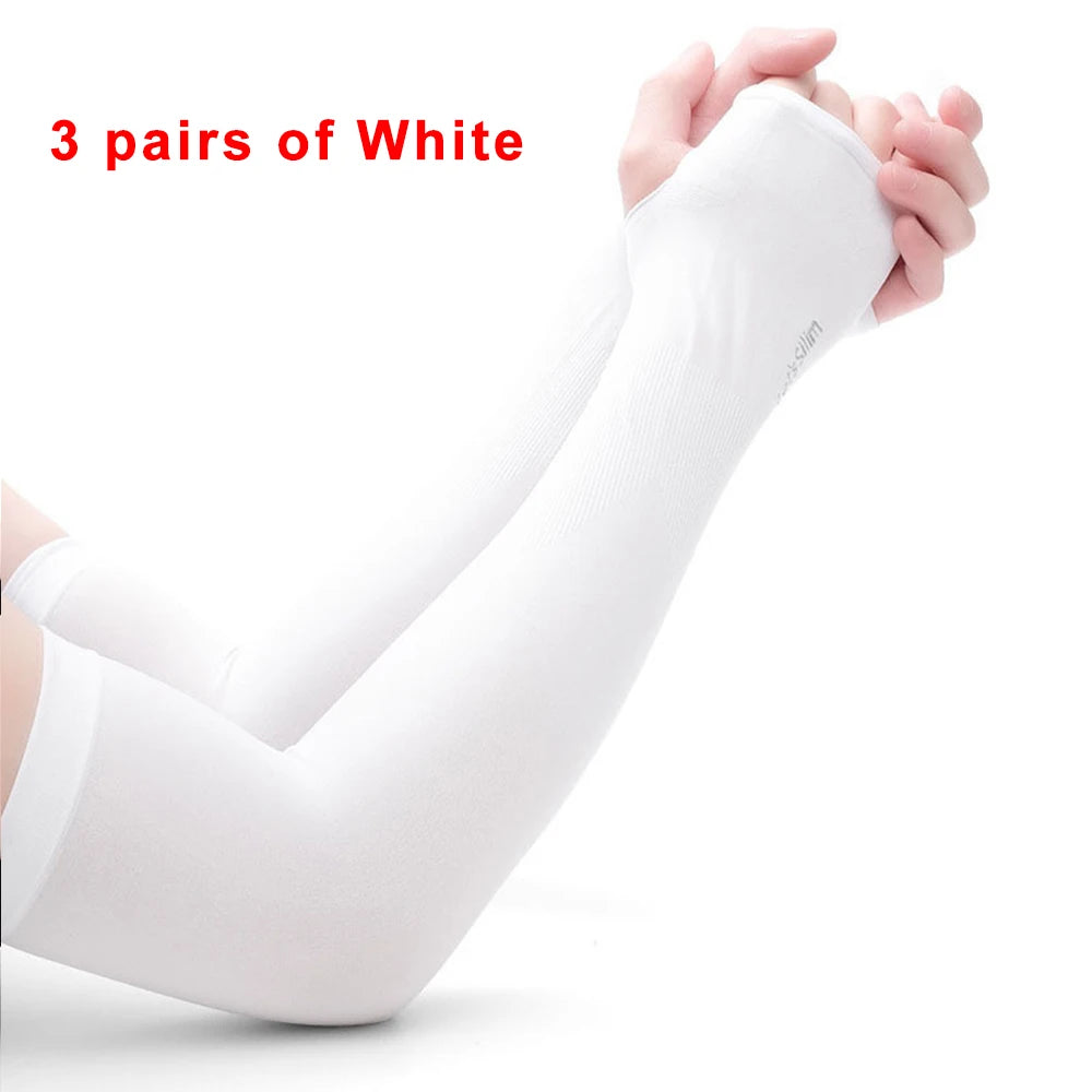Three pairs of white protective arm sleeves being held by hands.