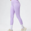 Model in seamless high-waist yoga leggings and matching crop top in light purple.