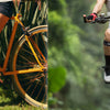 A person riding a bicycle outdoors wearing an adjustable patellar tendon support knee brace.