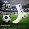 A pair of white grip soccer socks is displayed next to a soccer ball on a green field.