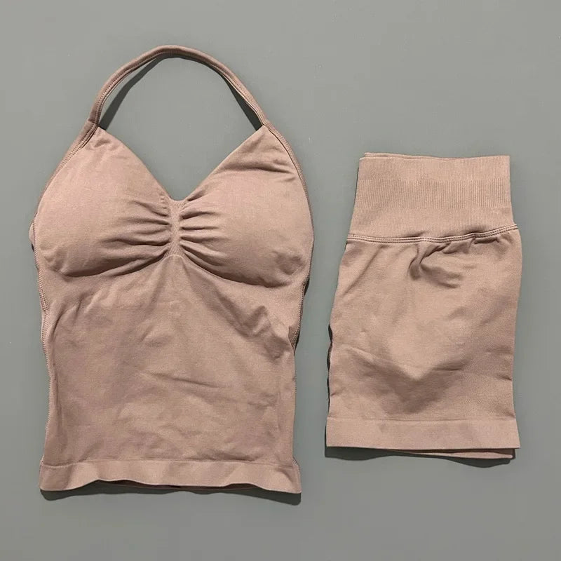 A beige women's seamless fitness set consisting of a cropped top and matching shorts.
