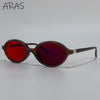 A pair of brown-framed sunglasses with red tinted lenses resting on a white background.