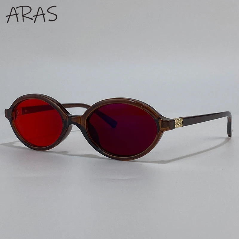 A pair of brown-framed sunglasses with red tinted lenses resting on a white background.