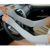 A person is wearing light gray breathable arm sleeves while driving a car.