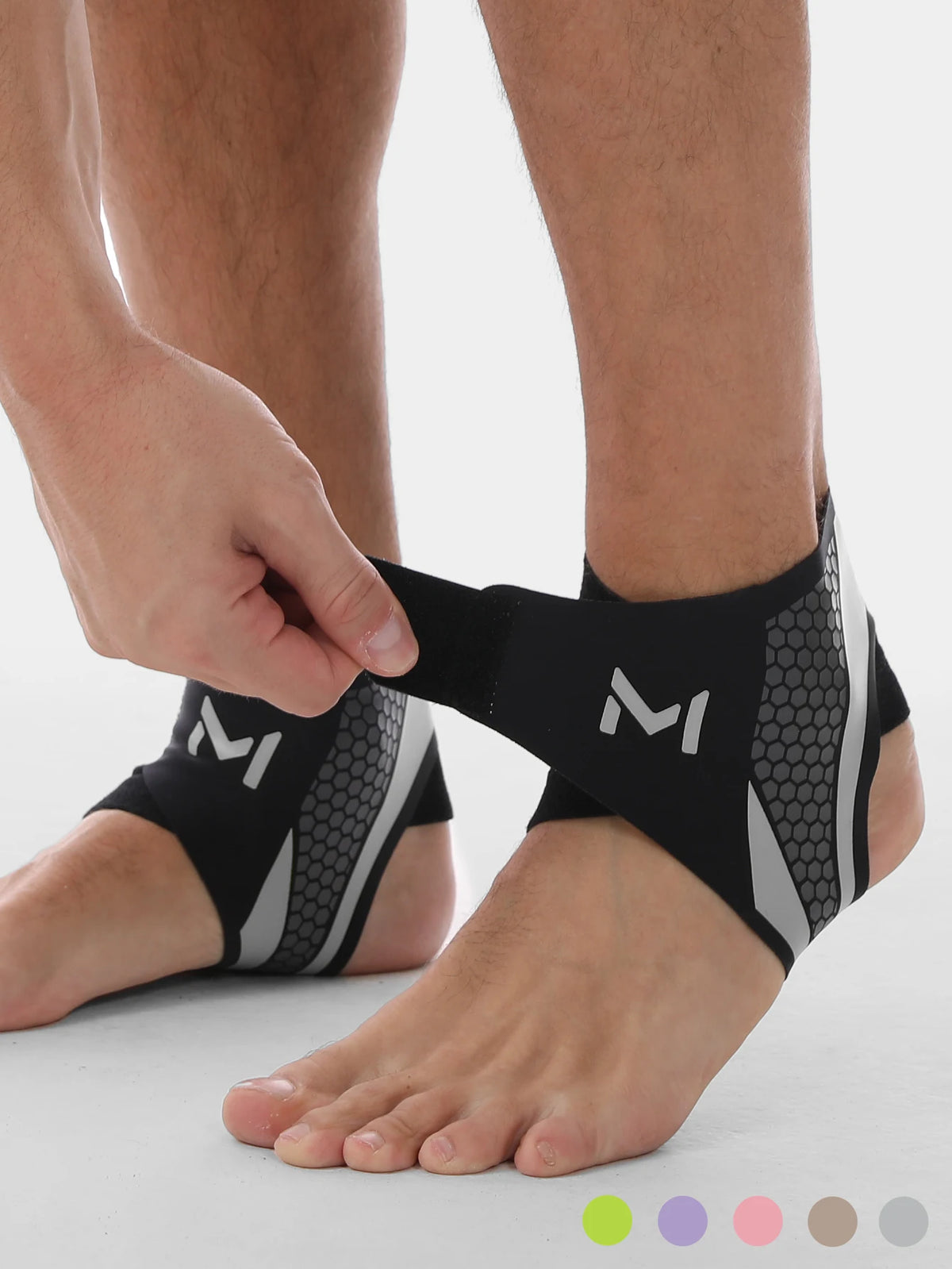 A person's foot is shown wearing black and gray compression ankle support foot sleeves.