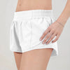 White women's high-waisted running shorts shown on a model.