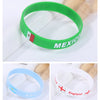 Three silicone wristbands in green, light blue, and white featuring national flags of Mexico, Argentina, and England.
