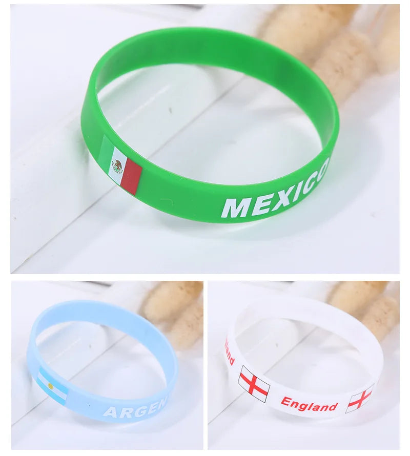 Three silicone wristbands in green, light blue, and white featuring national flags of Mexico, Argentina, and England.
