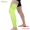 A bright lime green full leg compression sleeve worn on a person's leg.