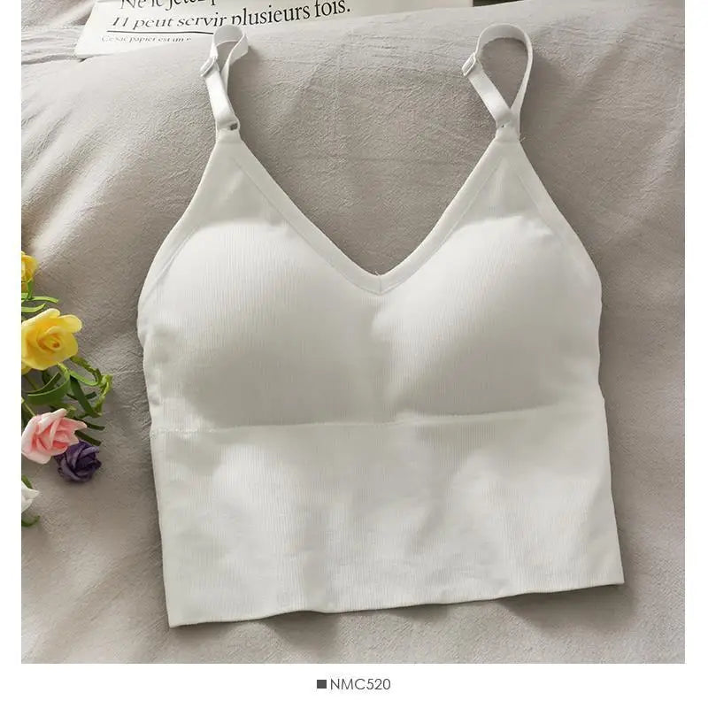 White off-shoulder camisole tank top for women displayed on a light fabric.