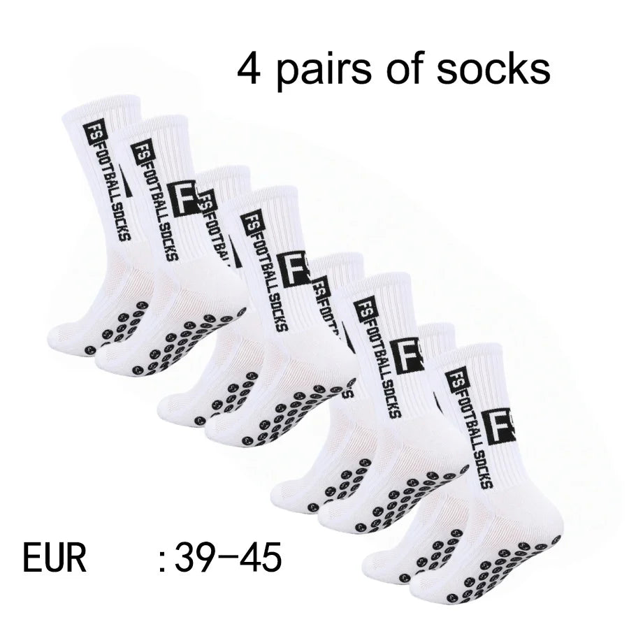 Four pairs of white athletic soccer socks with non-slip grips displayed on a white background.