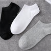 A display of three pairs of breathable men's sports ankle socks in black, white, and gray.
