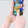 A hand wearing a pink ice silk sunscreen fabric sleeve is holding a smartphone with a fingertip flap sensitive touch screen.