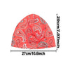 A bright coral pink printed headscarf cap for activewear, shown flat.