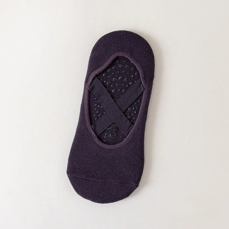 A dark purple non-slip yoga and gym sock with a silicone grip pattern.