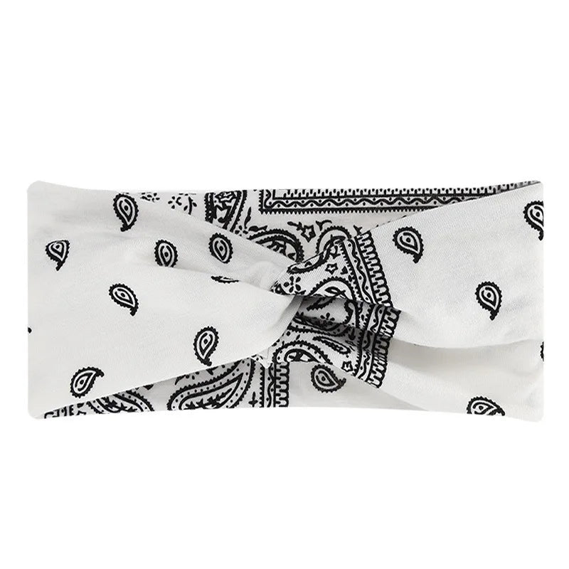 White fabric headband with black bohemian print design folded and tied