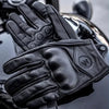 Black full finger leather motorcycle riding gloves shown in a close-up view.