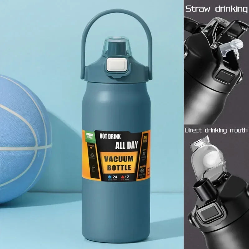 A tall, matte blue insulated water bottle with a silver straw drinking mechanism is shown next to a blue exercise ball.