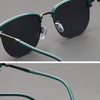 A close-up display of teal metal frame sunglasses with dark lenses shown from the front and side.