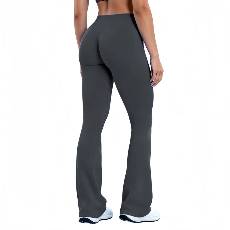 A model wearing dark gray seamless flared yoga leggings and a sports bra.