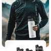 A man wearing a black athletic shirt holds a white insulated stainless steel thermal water bottle.
