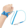 A hand is wearing a blue ESD wrist strap connected by a wire to a small metal clip.