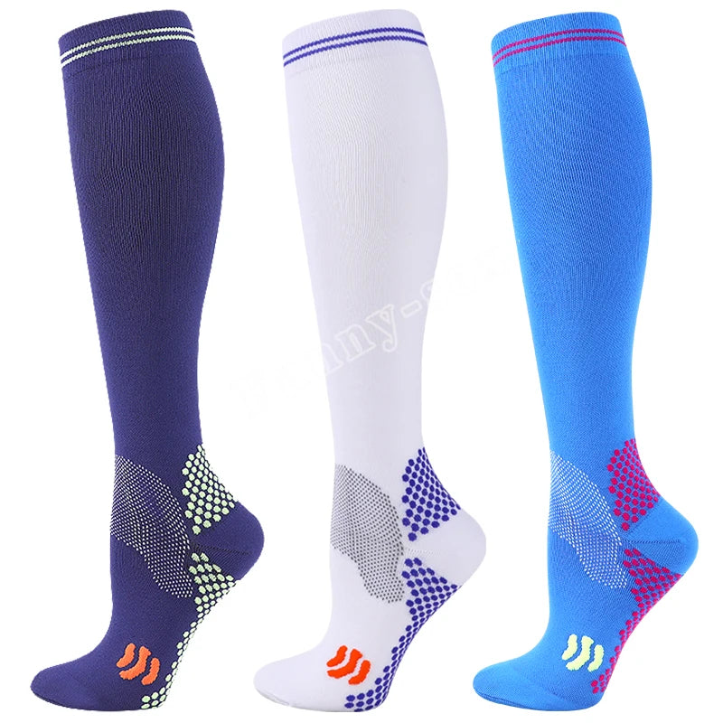 Three pairs of medical grade compression socks in navy blue, white, and bright blue.