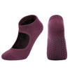 A pair of deep purple breathable women's Pilates and yoga socks shown from the side.