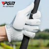 A hand wearing a white grip glove is holding a golf club shaft outdoors.