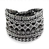 A black and white geometric patterned stretch cotton headband.
