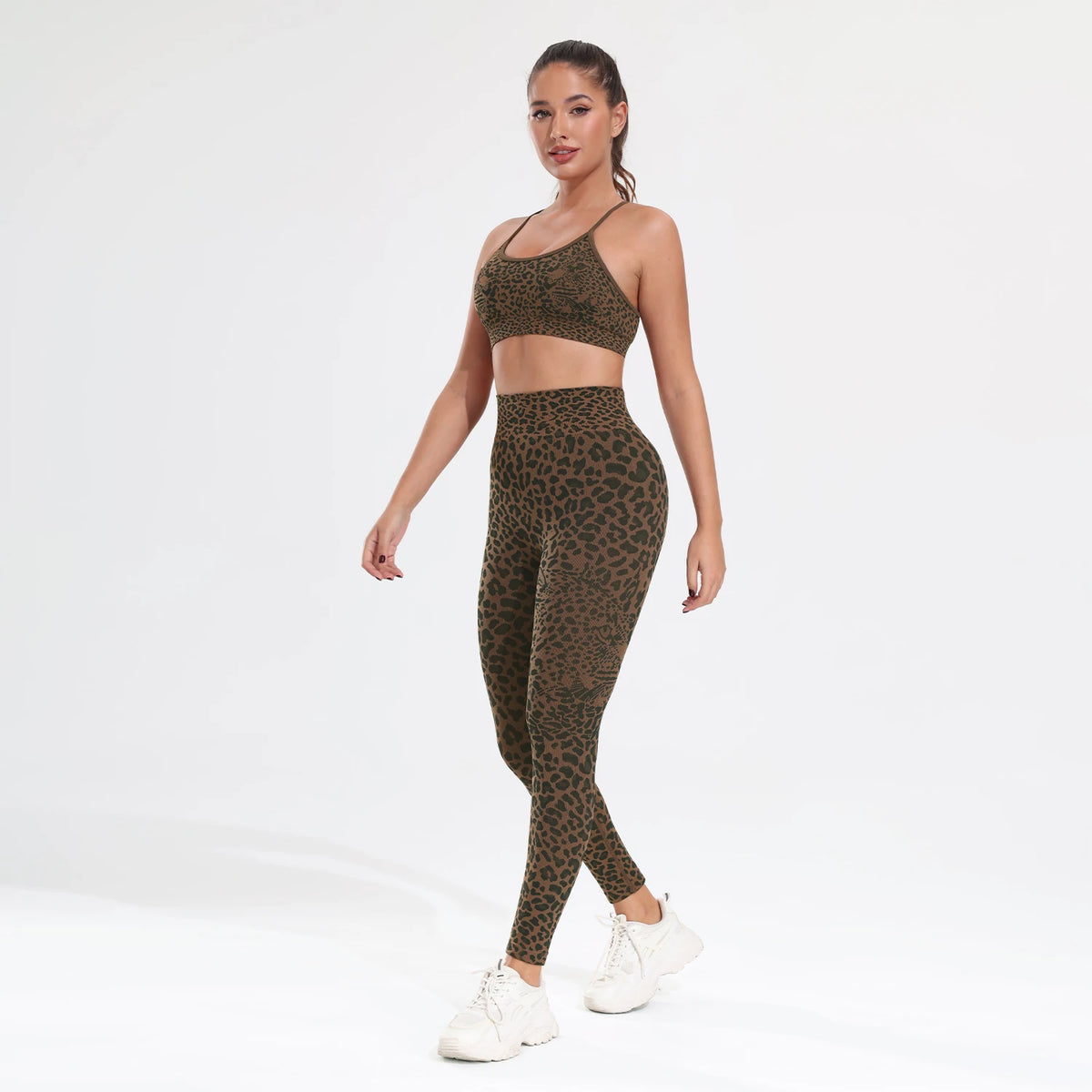 A woman models a leopard print seamless two-piece sports set consisting of a crop top and leggings.