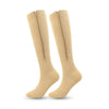 A pair of beige high elasticity compression socks shown standing upright.