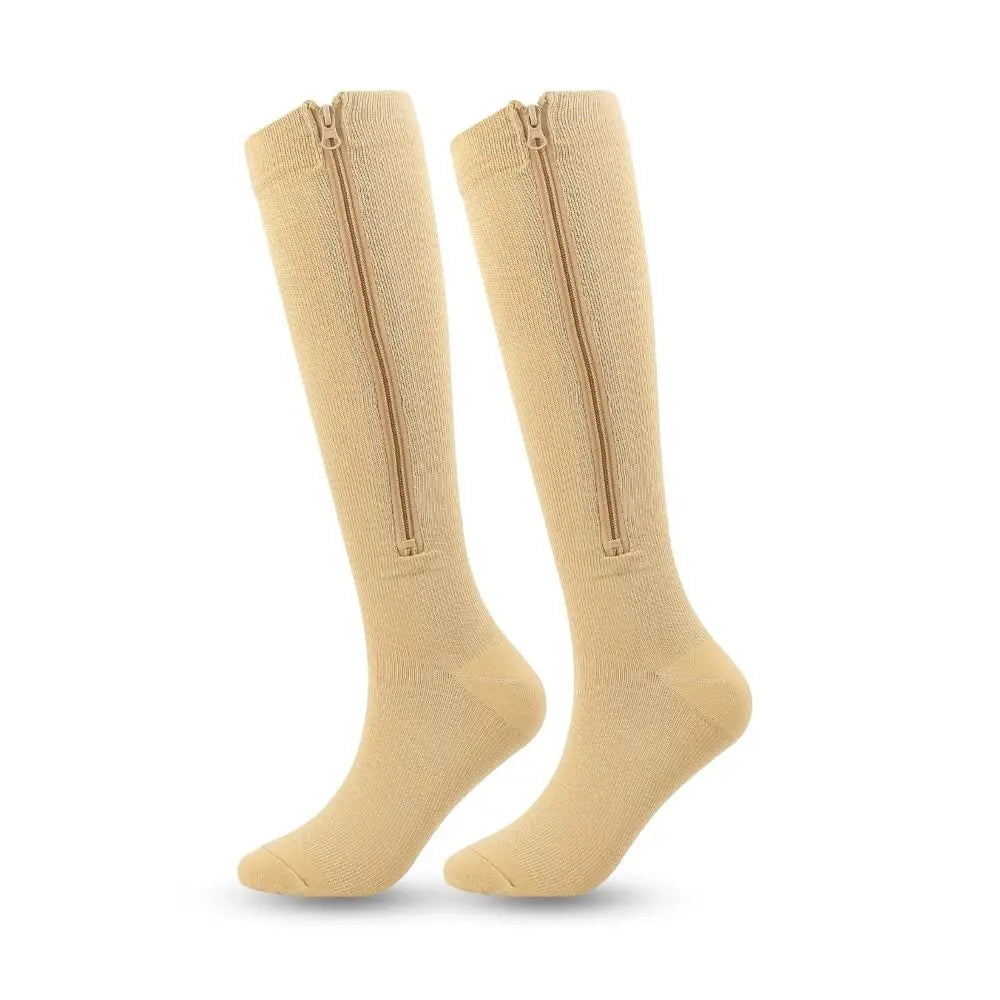 A pair of beige high elasticity compression socks shown standing upright.