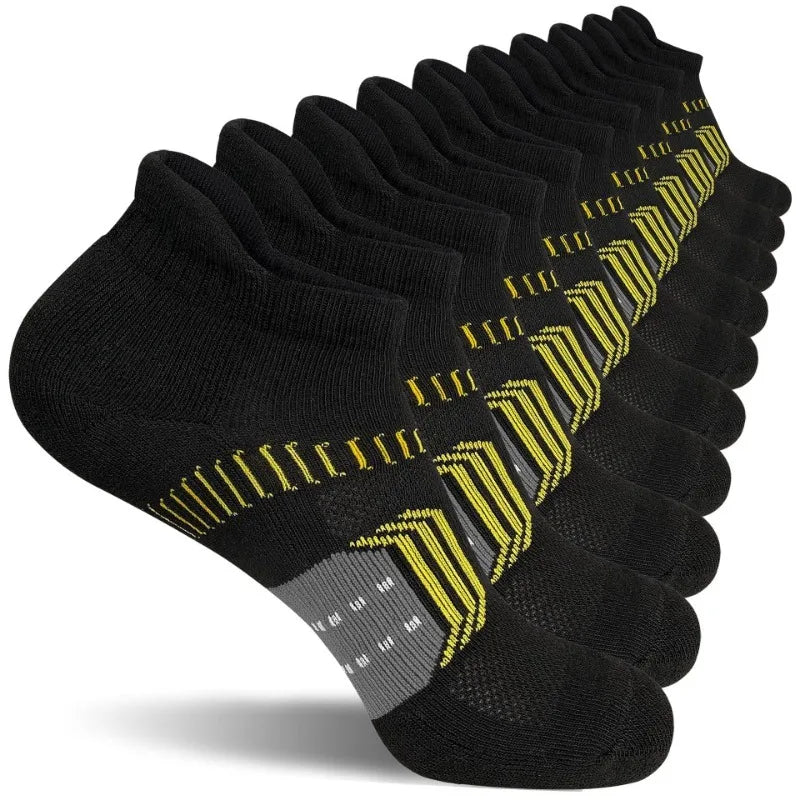 A stack of black women's performance ankle socks with yellow accents, showing various compression and cushion support levels.