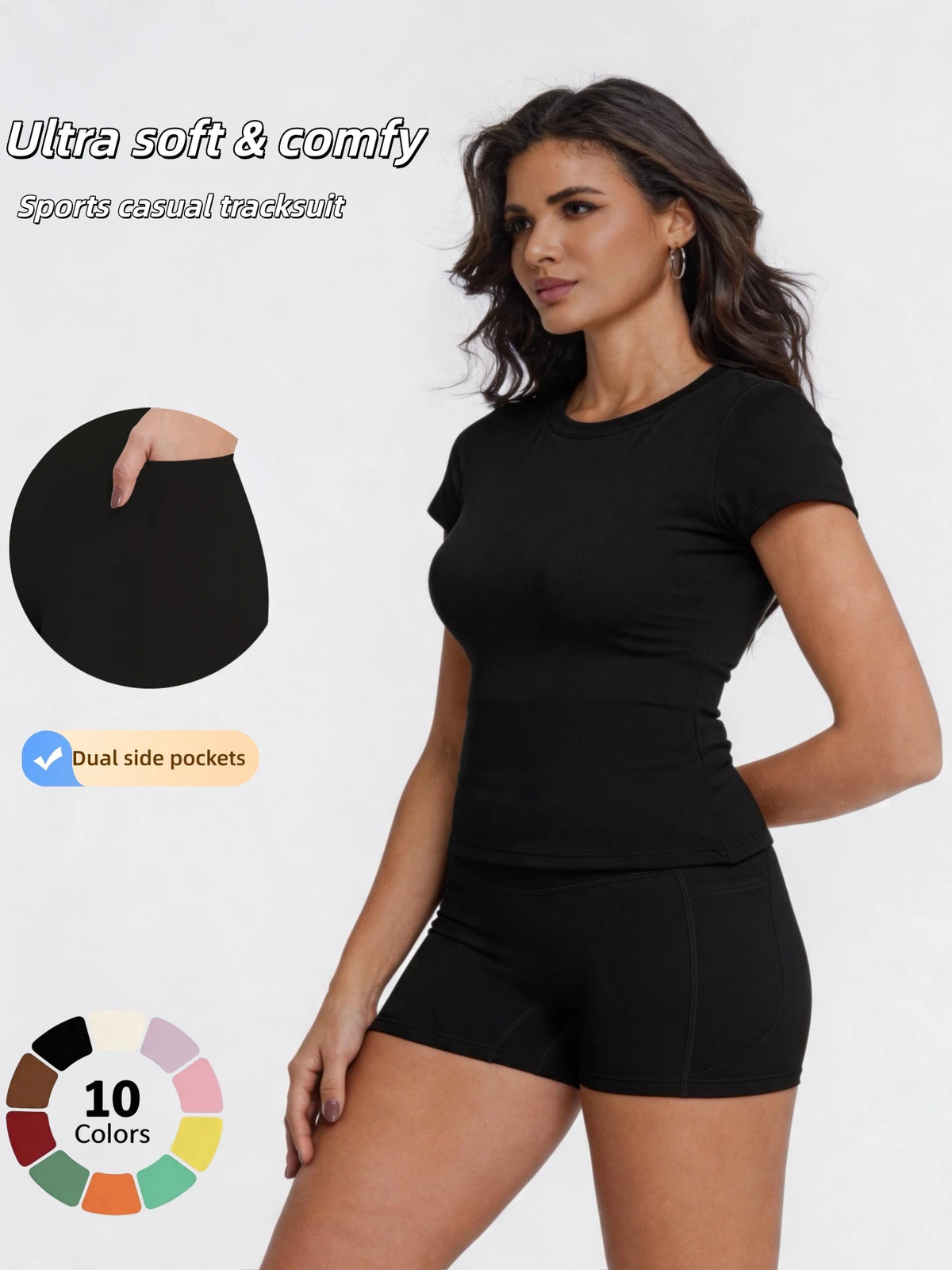 A woman models a black sports casual tracksuit consisting of a fitted top and shorts.