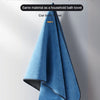 A folded blue bath towel used for cleaning car paint and removing stains.